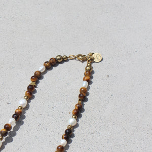 Resilience necklace with Tiger’s Eye, Jasper, Freshwater Pearls and Hematite in gold-plated stainless steel.